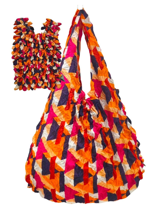 Be Bougie reusable tote bag in electric orange, hot pink, and navy with a textured, crinkled geometric pattern.
