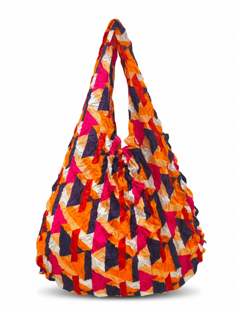 Be Bougie reusable tote bag in electric orange, hot pink, and navy with a crinkled geometric pattern.