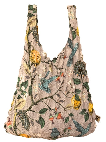 Be Bougie reusable tote bag with a hummingbird, lemon, and botanical print on a neutral crinkled fabric