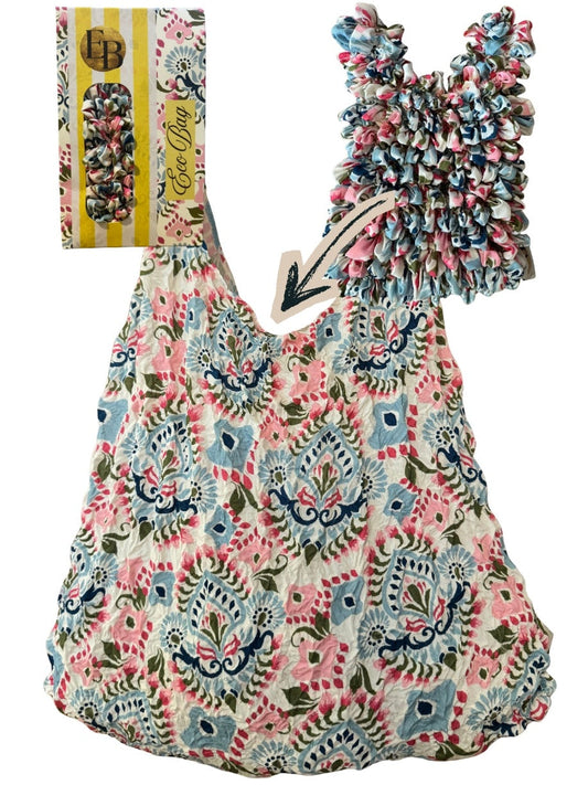 Be Bougie paisley print sustainable stretchy eco tote bag in blue, pink, and red, shown expanded and folded.