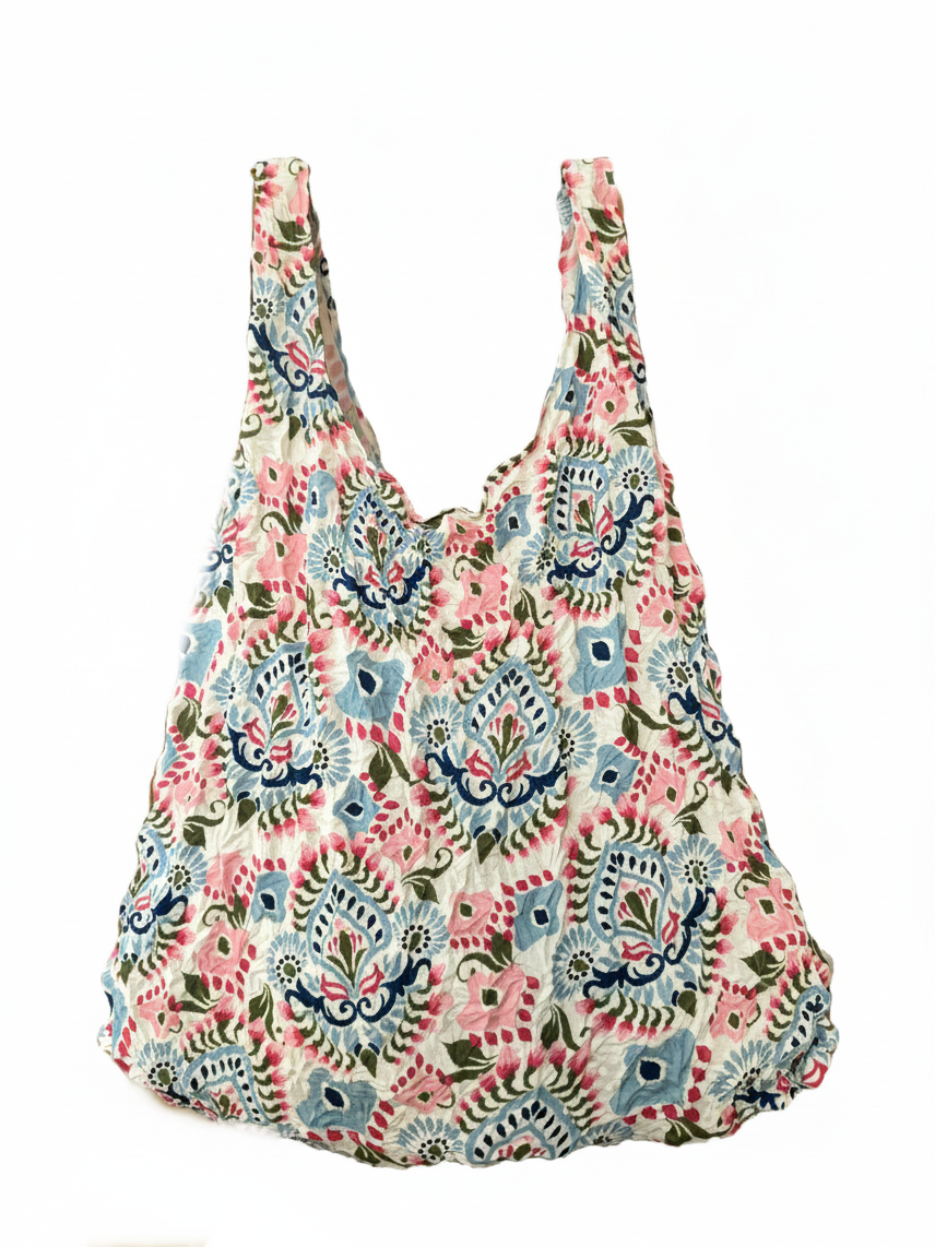 Be Bougie sustainable stretchy eco tote bag featuring a vibrant blue, pink, and red paisley floral pattern.