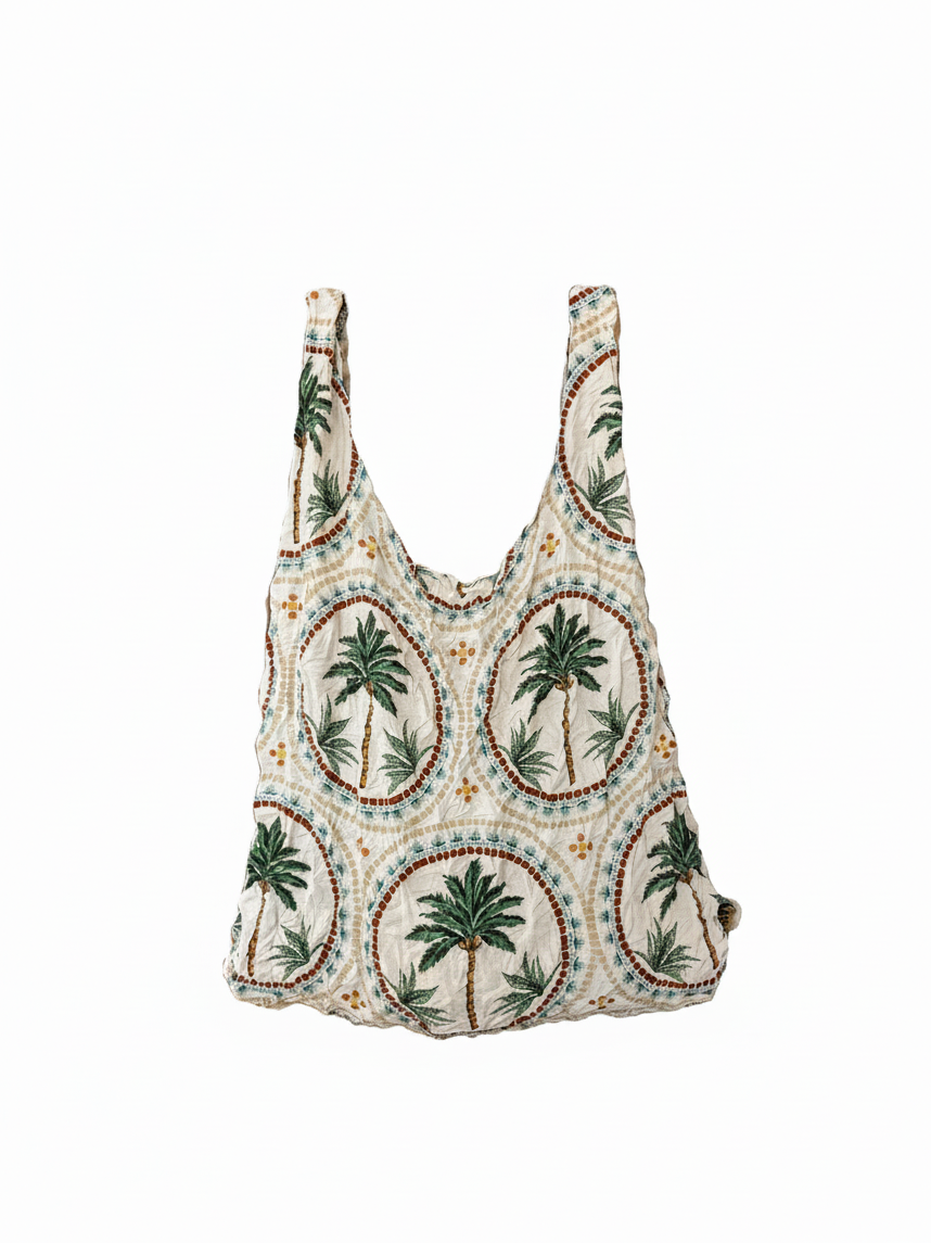 Be Bougie palm tree mosaic print eco-friendly stretchy tote bag in cream, green, and brown on a white background.