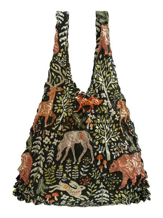 Be Bougie stretchy eco tote bag in dark green  with a whimsical woodland print featuring deer, bears, and forest flora.