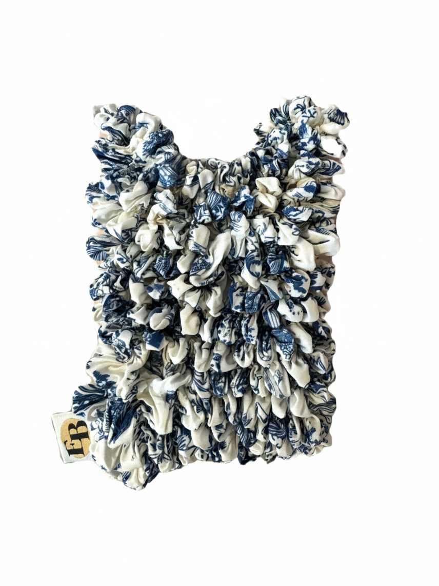 Be Bougie Toile sustainable stretchy eco tote bag in a blue and white floral pattern, shown in compact folded state.