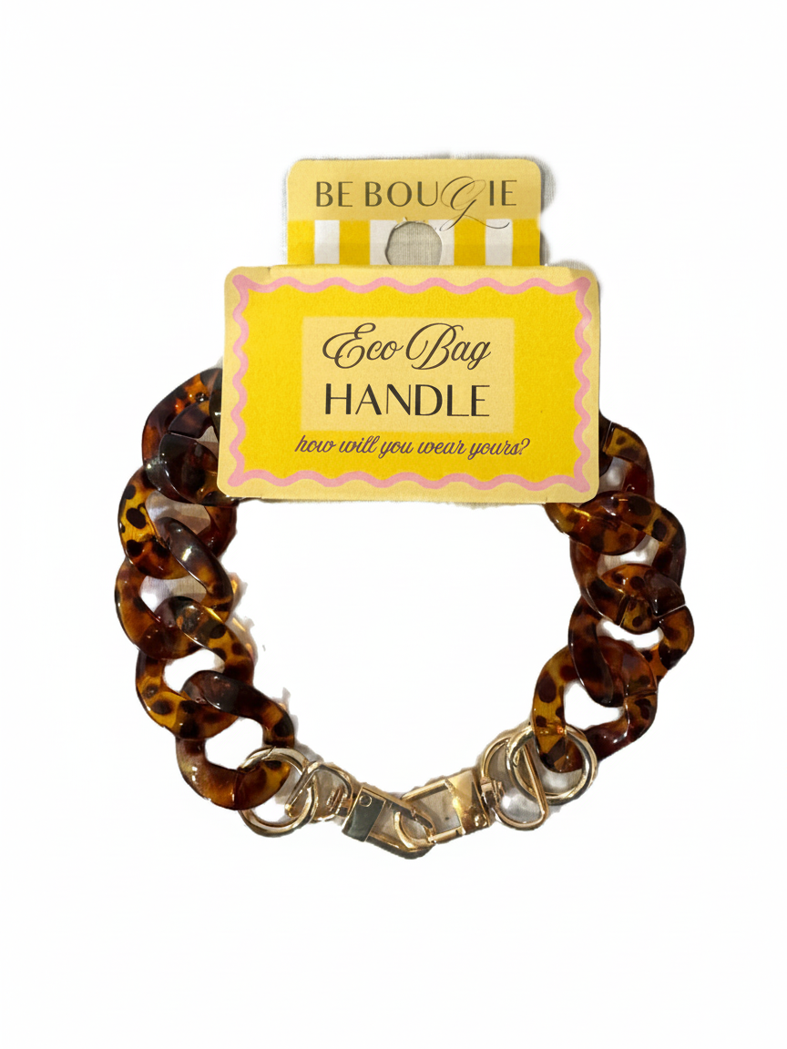 Be Bougie tortoiseshell chain link bag handle accessory with gold-tone metal clips on branded yellow display card.